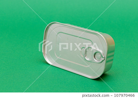 Unopened Tin Can with Blank Edge on Green Background Unopened Tin Can with Blank Edge on Green Background 107970466