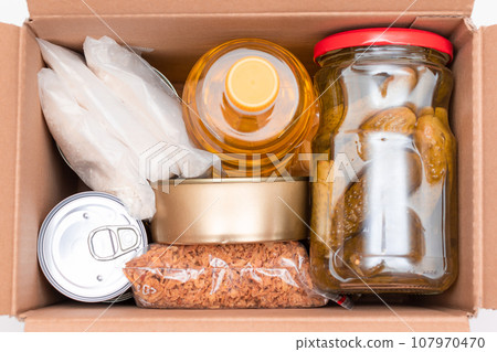 Carton Box with Canned Food, Cereals and Grocery - Donation Box or Food Reserves Carton Box with Canned Food, Cereals and Grocery - Donation Box or Food Reserves 107970470