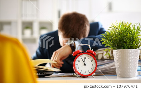Red alarm clock shows late time closeup Red alarm clock shows late time closeup 107970471