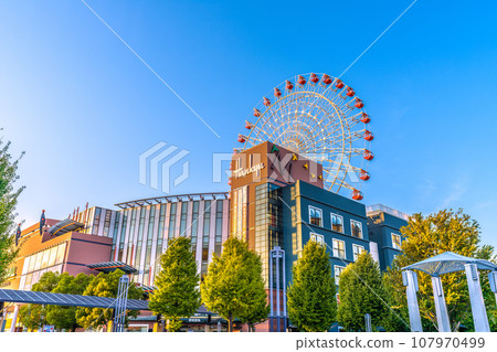 Yokohama cityscape in Japan October. In front of Center Kita Station, view of the Ferris wheel and Tsuzuki Hankyu, etc., reflected in the blue sky and sunset 107970499
