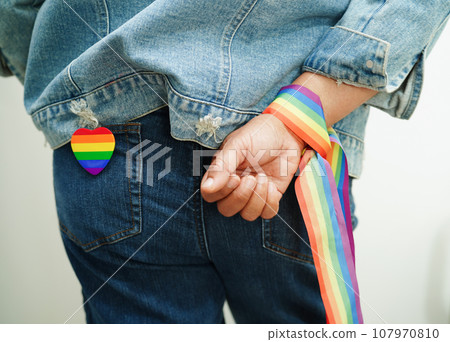 Asian woman with rainbow flag, LGBT symbol rights and gender equality, LGBT Pride Month in June. 107970810