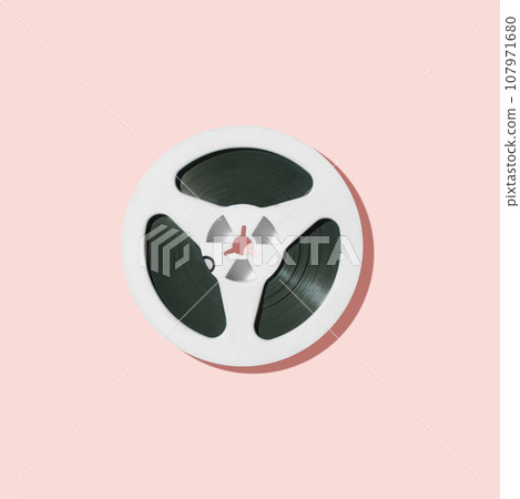 White reel for tape recorder isolated on pink background. White reel for tape recorder isolated on pink background. 107971680