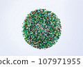 On a white background, a pattern of small colored beads in the form of a circle. 107971955