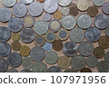 A collection of coins from different countries and times on a craft background. 107971956