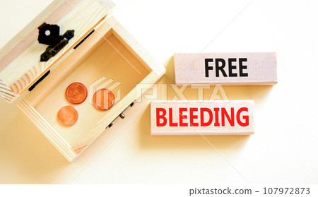 Free bleeding symbol. Concept words Free bleeding on beautiful wooden block. Beautiful white table background. Wooden chest with coins. Gen Z, motivational freedom free bleeding concept. Copy space. 107972873
