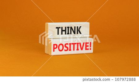 Think positive symbol. Concept words Think positive on beautiful wooden block. Beautiful orange table orange background. Business, motivational think positive thinking concept. Copy space. Think positive symbol. Concept words Think positive on beautiful wooden block. Beautiful orange table orange background. Business, motivational think positive thinking concept. Copy space. 107972888