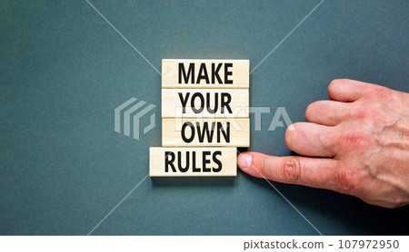 Make your own rules symbol. Concept words Make your own rules on wooden cubes. Beautiful grey table grey background. Businessman hand. Business motivational make your own rules concept. Copy space Make your own rules symbol. Concept words Make your own rules on wooden cubes. Beautiful grey table grey background. Businessman hand. Business motivational make your own rules concept. Copy space 107972950