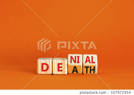 Denial death symbol. Concept words Denial Death on wooden block. Beautiful orange table orange background. Business denial death concept. Copy space. 107972954
