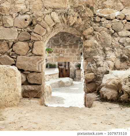 Doorway with an arch in a ancient stone wall Doorway with an arch in a ancient stone wall 107973510
