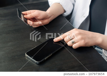 Online Shopping at Your Fingertips. Female Hands with Credit Card and Smartphone. Seamless E 107973654
