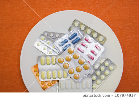 Pills and capsules with fork - food, protection quarantine, coronavirus, covid19 Pills and capsules with fork - food, protection quarantine, coronavirus, covid19 107974937