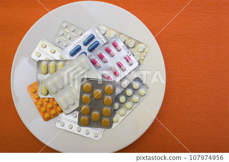 Pills and capsules with fork - food, protection quarantine, coronavirus, covid19 Pills and capsules with fork - food, protection quarantine, coronavirus, covid19 107974956