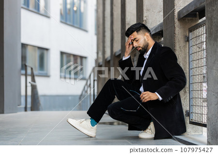Unhappy sad Indian business man frustrated stress feeling bad after company unemployment lost job Unhappy sad Indian business man frustrated stress feeling bad after company unemployment lost job 107975427