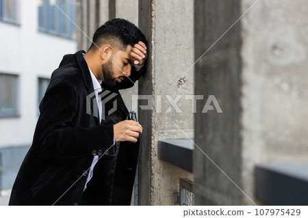 Unhappy sad Indian business man frustrated stress feeling bad after company unemployment lost job Unhappy sad Indian business man frustrated stress feeling bad after company unemployment lost job 107975429