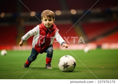 Dribbling small boy plays football in stadium. Generative AI 107976178