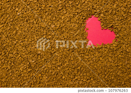 Dry instant coffee granules in the shape of a heart - brown texture Dry instant coffee granules in the shape of a heart - brown texture 107976263