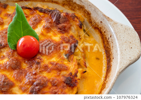 Homemade Vegetarian Lasagna with Tomato and Basil Sauce on wooden table. Close up. 107976324