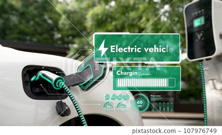 Electric car plug into EV charger display battery status hologram.Peruse 107976749