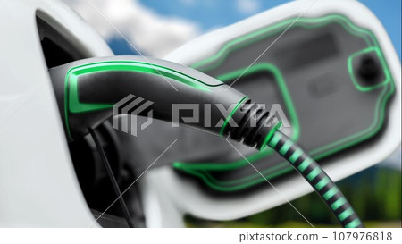 Future EV charger plugged into electric car for electric recharging. Peruse Future EV charger plugged into electric car for electric recharging. Peruse 107976818