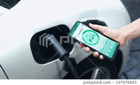 Smartphone display battery status interface by smart EV app. Peruse Smartphone display battery status interface by smart EV app. Peruse 107976883