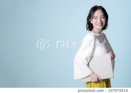 Woman with a laptop, refreshing green background Woman with a laptop, refreshing green background 107978918