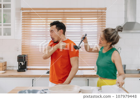 Husband taste wife cook and pretend that it is delicious. Funny couple. 107979448