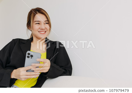 Happy and smile face woman using smartphone in white room. Happy and smile face woman using smartphone in white room. 107979479
