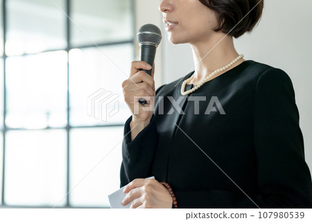 穿著喪服的女人用麥克風說話 穿著喪服的女人用麥克風說話 107980539