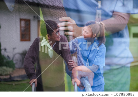 Double exposure physical therapist caregiver talking to senior man using a walker at home. concept home healthcare nurse, physical therapy with senior adult at home 107980992