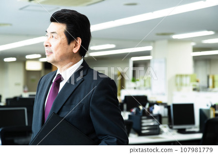 Middle-aged male manager working in the office Middle-aged male manager working in the office 107981779