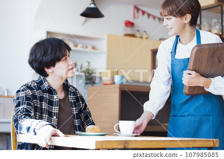 A woman working in a cafe A woman working in a cafe 107985085