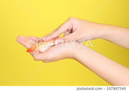 Hand with Sushi 107987540