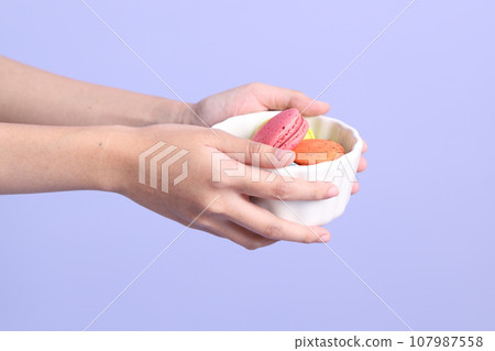 Hand with Macaroons 107987558