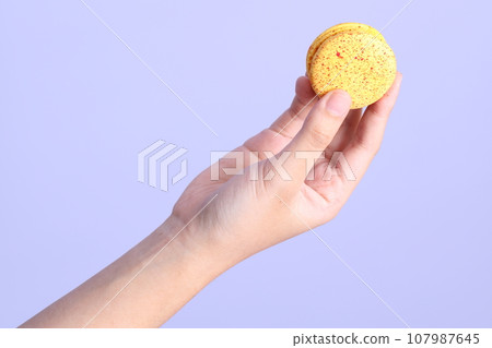 Hand with Macaroons 107987645