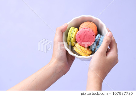 Hand with Macaroons Hand with Macaroons 107987780