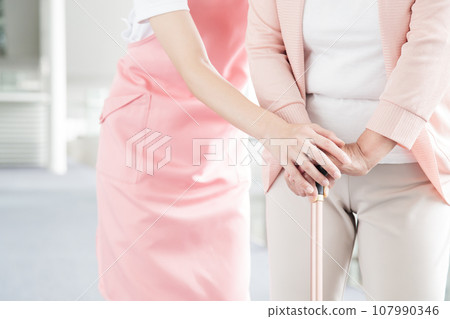 Young caregiver caring for elderly people at a nursing home Young caregiver caring for elderly people at a nursing home 107990346