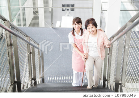 Young caregiver caring for elderly people at a nursing home 107990349