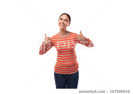 Young smart slim brunette woman dressed in a striped orange blouse and jeans on a white background 107990650
