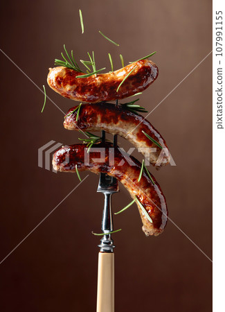 Grilled Bavarian sausages with rosemary. Grilled Bavarian sausages with rosemary. 107991155