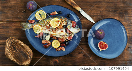 Baked sea bream dorada fish with figs. 107991494