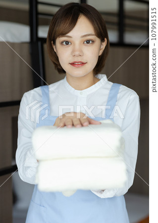 Cute woman making a bed Cute woman making a bed 107991515