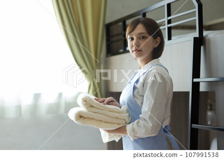 Cute woman making a bed 107991538