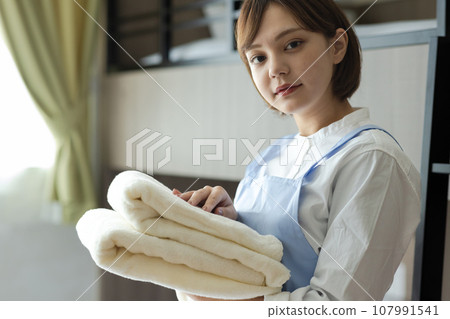 Cute woman making a bed 107991541