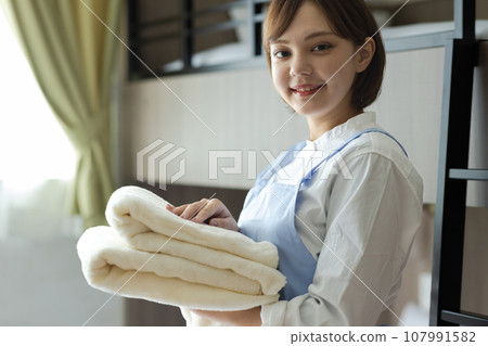 Cute woman making a bed 107991582
