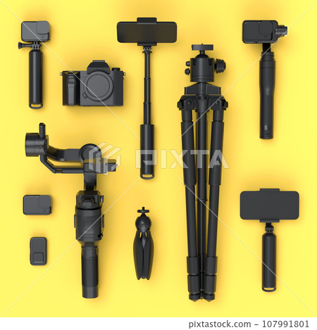 Top view of monochrome designer workspace and photography gear on yellow 107991801