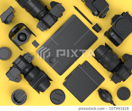 Top view of monochrome designer workspace and photography gear on yellow 107991826