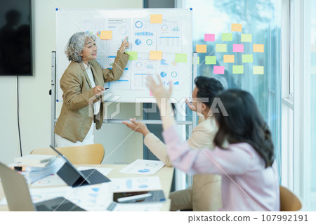 Asian entrepreneurs and business people meeting in a conference room in business planning, financial budget and investment risk assessment to analyze customer groups to increase company growth. Asian entrepreneurs and business people meeting in a conference room in business planning, financial budget and investment risk assessment to analyze customer groups to increase company growth. 107992191