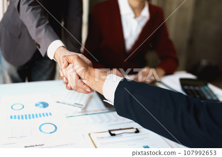 Asian entrepreneurs handshakes to congratulate the agreement between the two companies to enhance investment and financial strength. deal concept. 107992653
