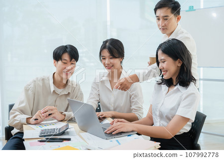 startup Asian business advisor meeting to analyze and discuss the situation on the financial report in the meeting room. startup Asian business advisor meeting to analyze and discuss the situation on the financial report in the meeting room. 107992778