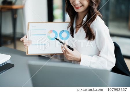 Business work and planning, portrait of a businesswoman using a computer in a meeting. Business work and planning, portrait of a businesswoman using a computer in a meeting. 107992867